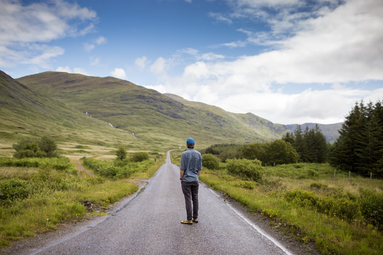 Man walking outdoors, promoting mindfulness in men's therapy.