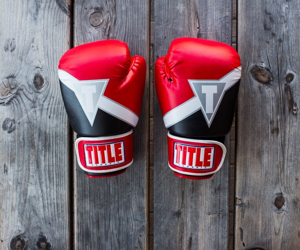 Pair of red boxing gloves, symbolizing anger management and therapy support.