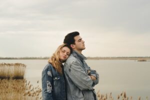 Couple standing on a stranded place with peaceful expressions, highlighting therapy support.