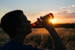 Man drinking alcohol, symbolizing substance abuse and therapy.