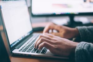 A man on his laptop addressing the growing problem of technology addiction.