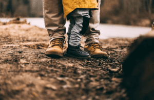 Close up of shoes of a man and his kid enjoying the outdoors