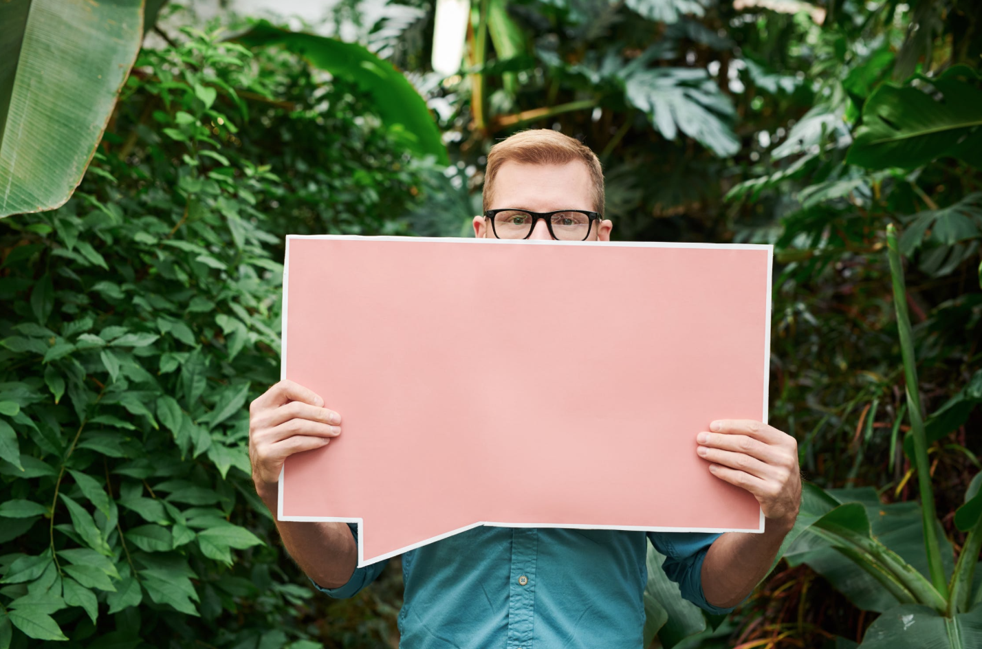 Man with an empty placard showcasing trapped thoughts, highlighting men's therapy needs.