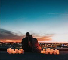 A couple sitting close surrounded by lanterns showcasing how couples reconnect after therapy.