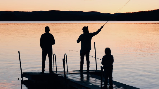 Men enjoying fishing by regaining work family life balance with expert therapists