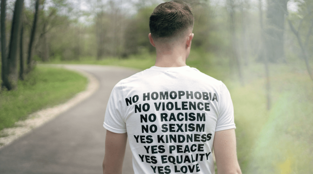 A man in white t-shirt promoting equality reflecting support for the GBTQ+ community in Denver.