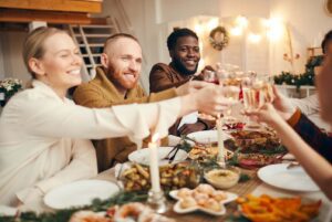 Family and friends at dinner table during holiday season