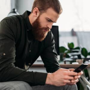 Man looking at his phone in deep thought