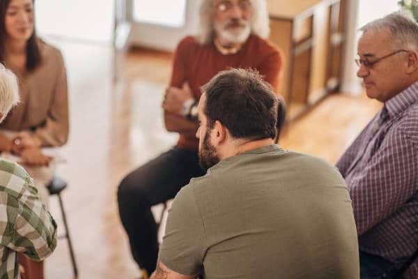 Men's group therapy session for male depression support.