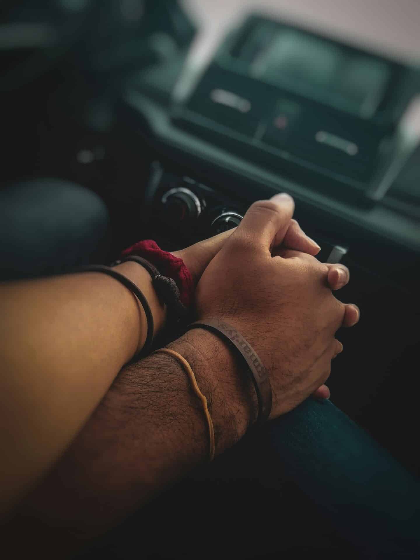 Couple holding hands in a car