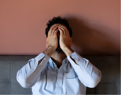 Man covering his face with hands expressing anxiety and stress requiring counseling in Denver