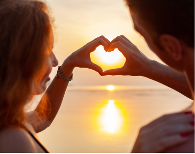 Couple making a heart shape with their hands showcasing healthy relationship after counseling in Denver.