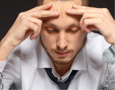 Concerned man with hands on his forehead, needing addiction counseling in Denver.