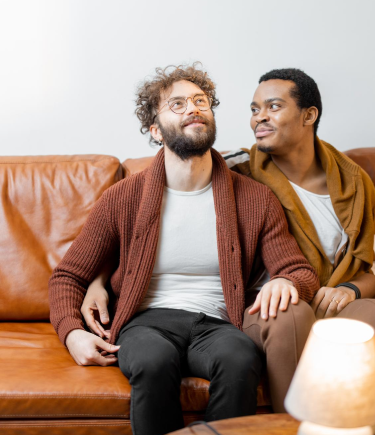 Banner image showing men sitting affectionately as they explore LGBTQ counseling options in Denver, CO.