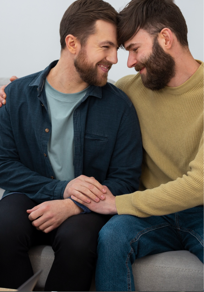 Couple smiling and embracing warmly after deciding to meet a queer therapist in Denver.