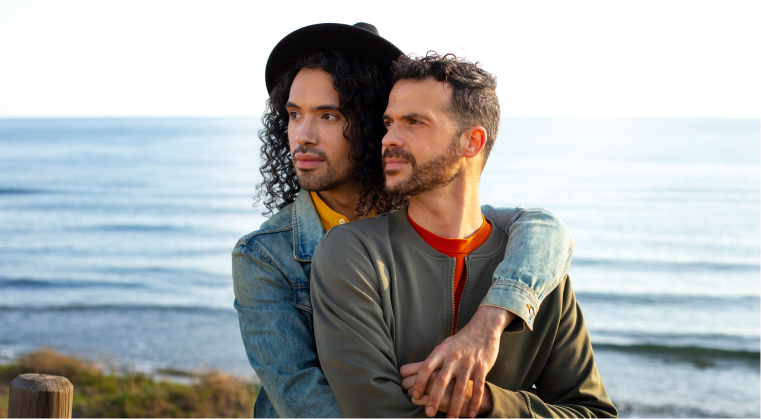 Couple standing at the seashore, gazing ahead with hope after LGBTQ couples therapy in Denver.