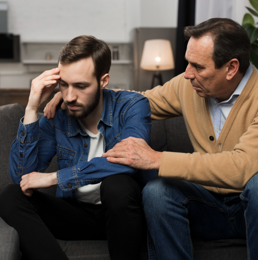 A man offering support to a stressed friend suggesting a grief counseling session in Denver