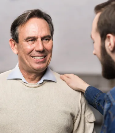 A man smiling after undergoing comprehensive care in Denver Men's Therapy.