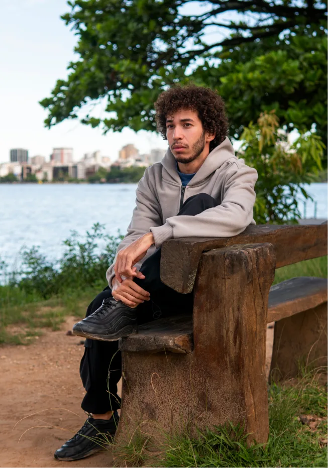 Man sitting on a bench, contemplating personal growth during therapy journey in Denver