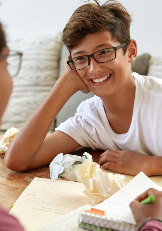 A cheerful youth with spectacles, smiling after a therapy session in Denver.