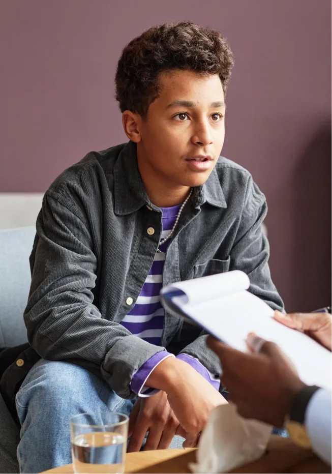 A teenager seeking guidance from child therapist in Denver