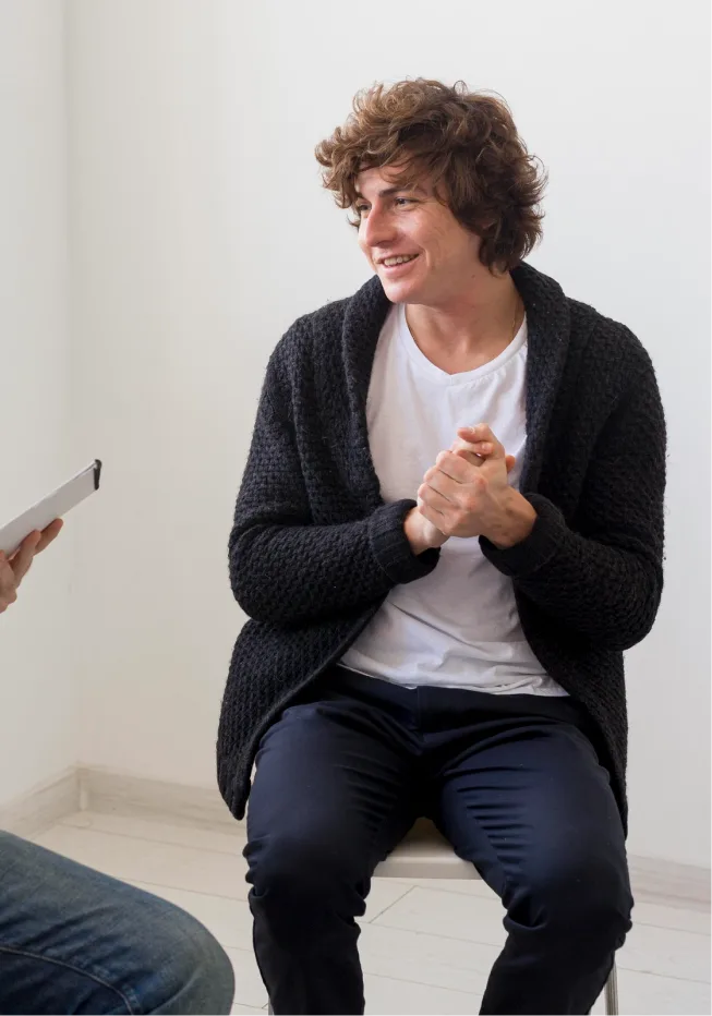 An enthusiastic teenager smiling and taking charge of his life after completing counseling.