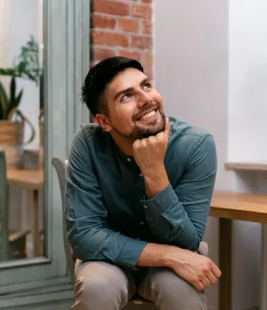 Man smiling confidently after stress counseling in Denver, ready to face new challenges