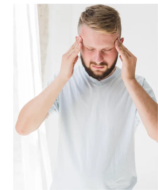 An overwhelmed man considering stress counseling in Denver to alleviate headaches