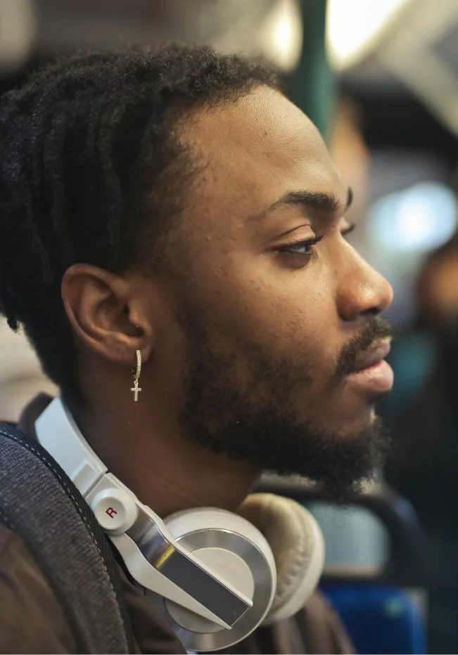 Man contemplating depression counseling in Denver, headphones around neck