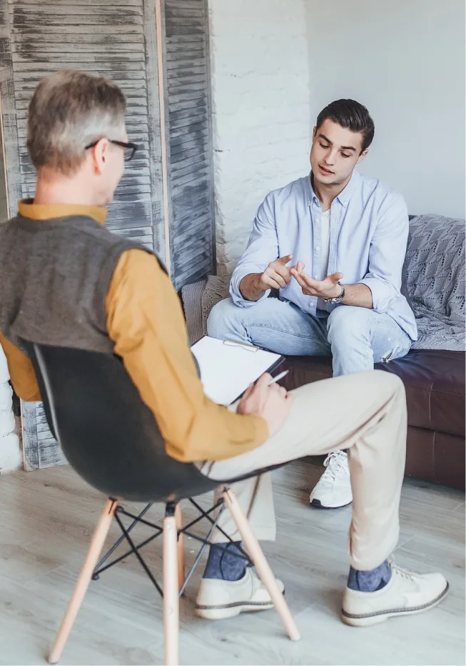 Man opens up to empathetic therapist in a supportive environment