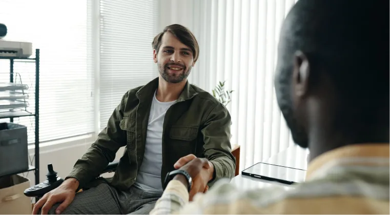 Man shaking hands with his therapist, demonstrating trust in psychedelic therapy in Denver.