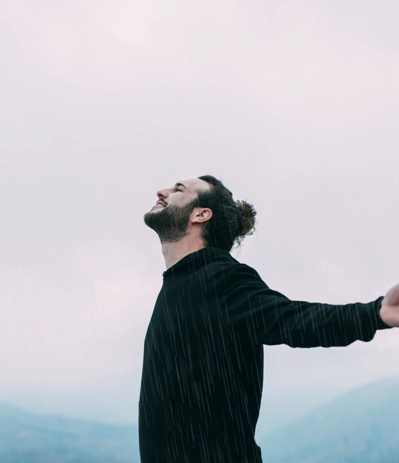 Man enjoying nature with open arms after successful religious trauma counseling in Denver.