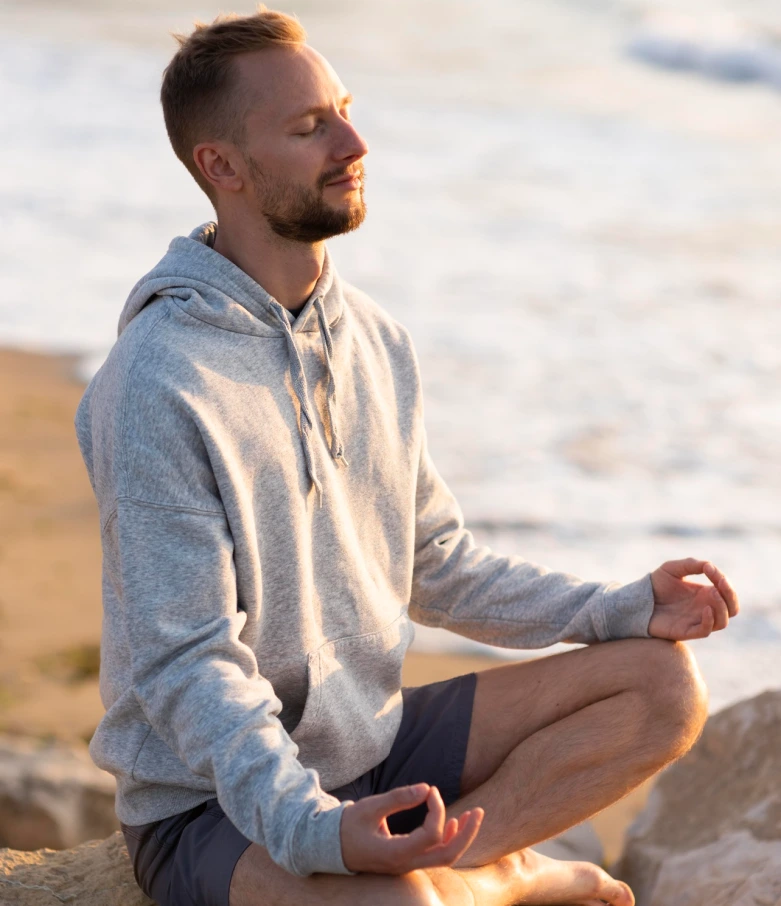 Man experiencing calm while meditating after learning anger management strategies.