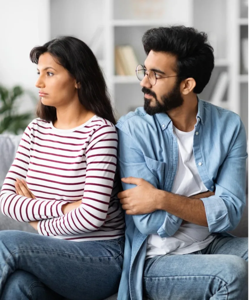 Woman looking away sadly while the man appears confused and distressed