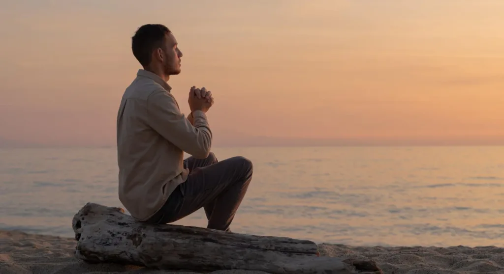 man sitting quietly by the lake feeling peaceful after religious trauma counseling in Denver