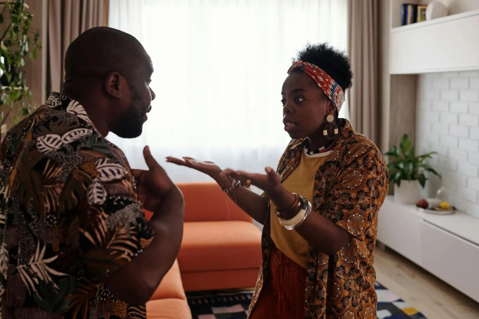 Couple arguing in living room, illustrating signs of feeling smothered in a relationship and emotional tension