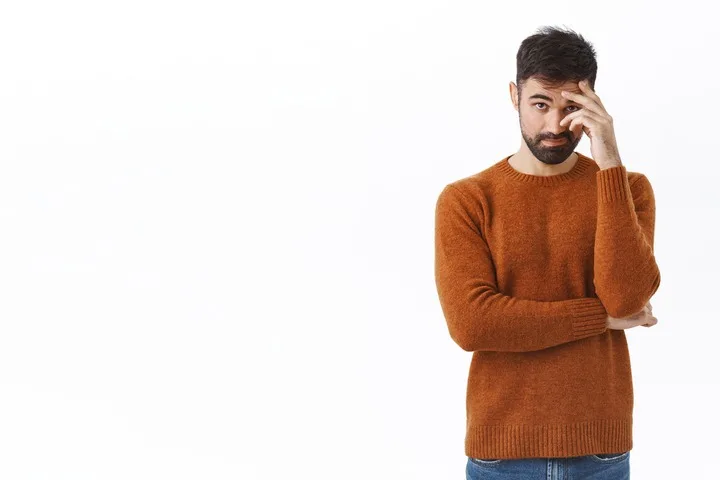 Man looking awkward and embarrassed, showing physical signs of embarrassment in men.