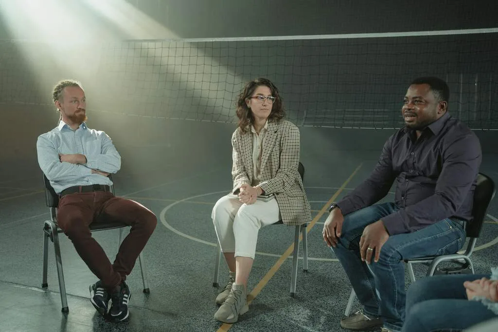 Men and women discussing their uncomplicated PTSD symptoms in a therapy session