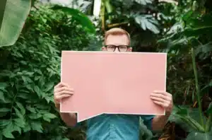 Man with an empty placard showcasing trapped thoughts, highlighting men's therapy needs.
