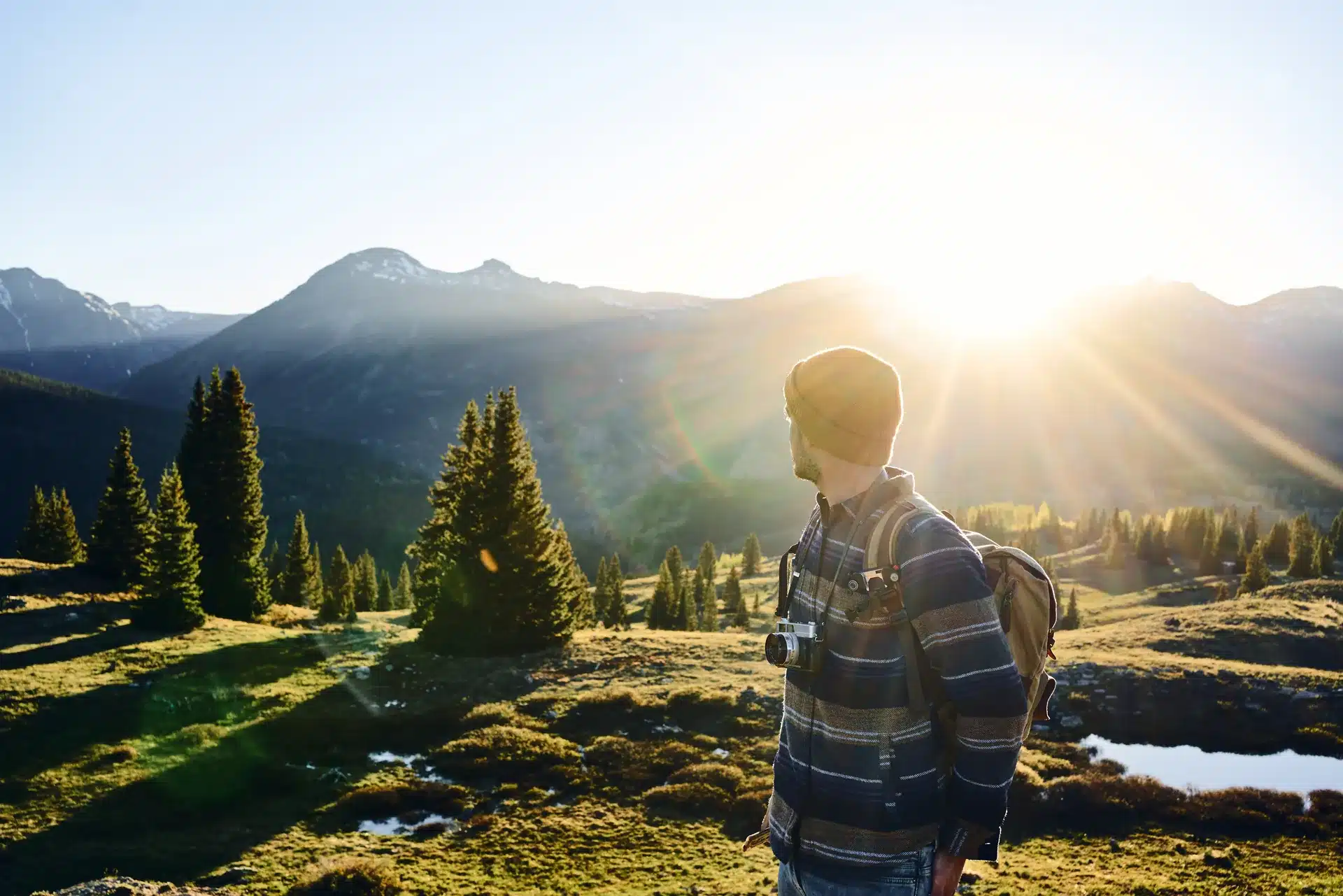 Man hiking in the mountains at sunrise