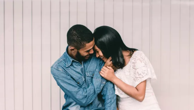 Man giggling with partner, representing a happy relationship